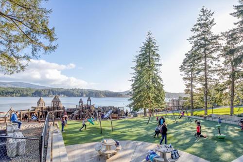 a group of people playing in a park with a playground at Laurel Haven - Meredith Lodging in Otis
