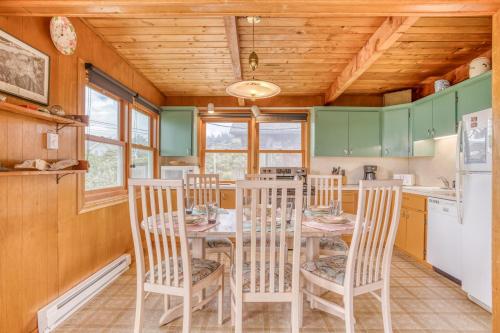 a dining room with a table and chairs in a kitchen at Sea Here - Meredith Lodging in Neskowin