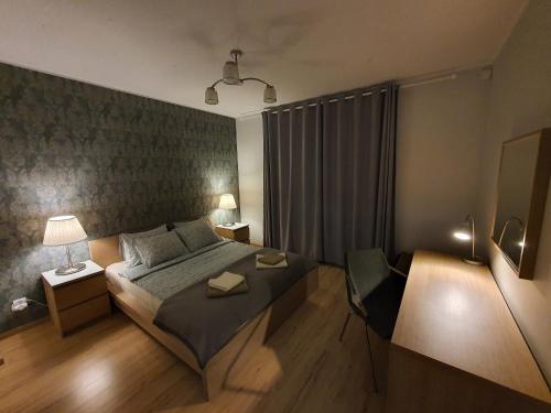 מיטה או מיטות בחדר ב-Apartamenty Morskie Perła i Bursztyn