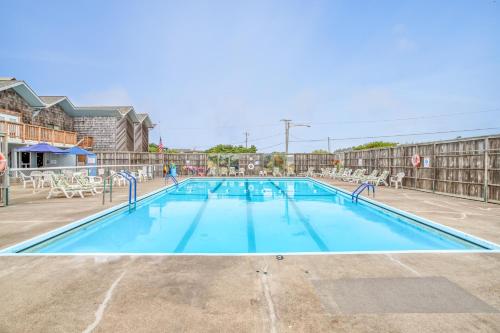 a large swimming pool with blue water and chairs at ACE Cabin in Waldport