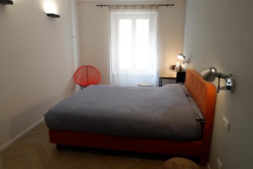 a small bedroom with a bed and a window at MUROS - City Modern Living in Trento in Trento