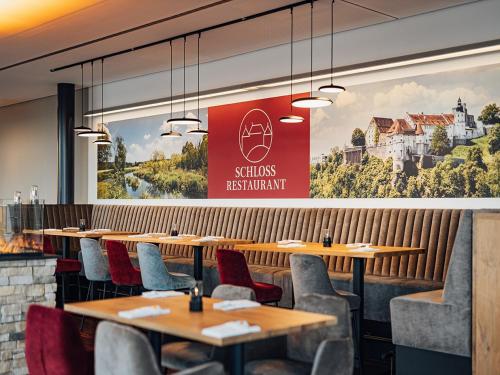 a row of tables and chairs in a restaurant at Schlosshotel Hellenstein in Heidenheim