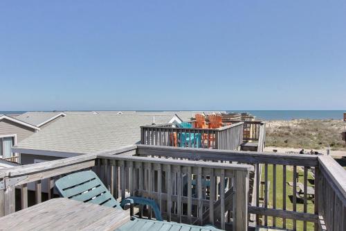 a deck with a table and chairs and the ocean at NC 12 56821-23 Condo in Hatteras
