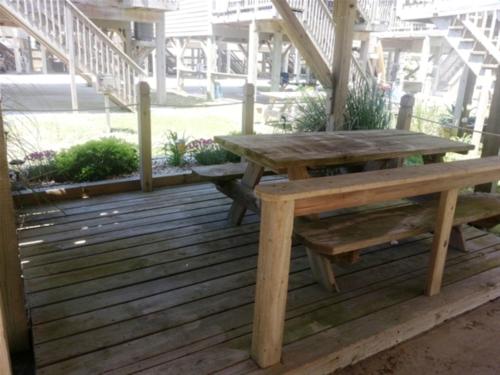 a wooden picnic table and bench on a deck at NC 12 56821-23 Condo in Hatteras