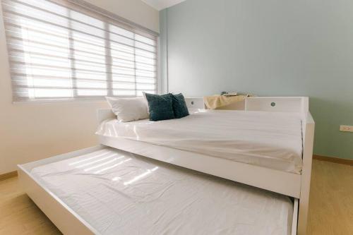 a large white bed in a room with a window at Two Bedroom Residential Home with own parking in Angeles