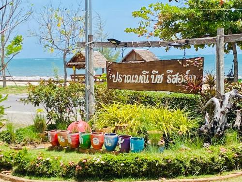 a sign for a garden with colorful pots at Pranmanee Beach Resort in Sam Roi Yot