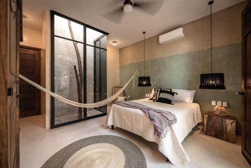 Una cama o camas en una habitación de Casona Origen Merida