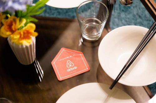 a table with plates and a cupcake and a candle at FANCY in Sapporo