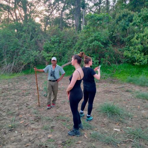 a group of people standing in a field at Hotel Tiger Tops Sauraha in Sauraha