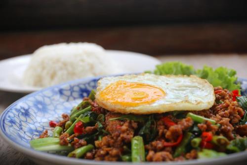a plate of food with rice and an egg on top at Lazy Beach in Koh Rong Sanloem