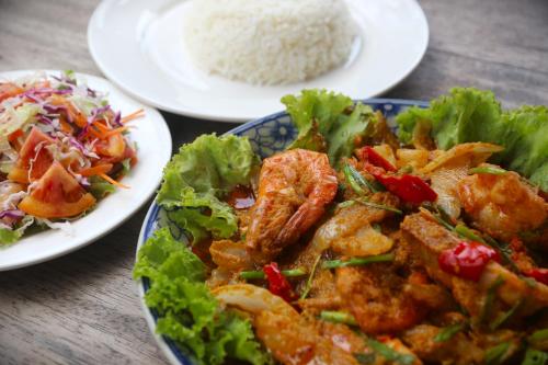 two plates of food on a table with rice at Lazy Beach in Koh Rong Sanloem