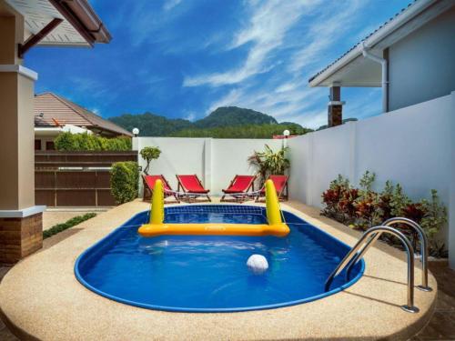 a swimming pool with a inflatable pool toy in a backyard at Aonang Symphony 3 Bedrooms Private Pool Villas in Ao Nang Beach