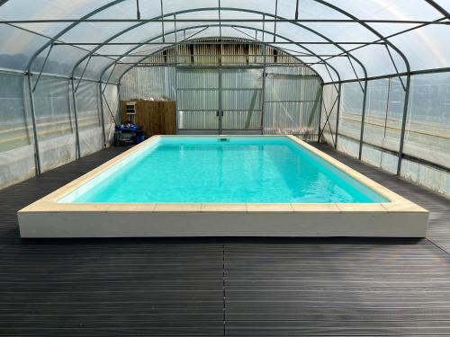 a large swimming pool inside of a building at Gîte à l’orée du pré in Villiers-Saint-Benoît