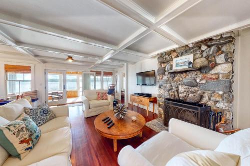 a living room with a large stone fireplace at Lakeshore Living in Monmouth