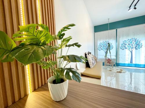 a plant sitting on a table in a room at The Cube Langkawi in Kuah