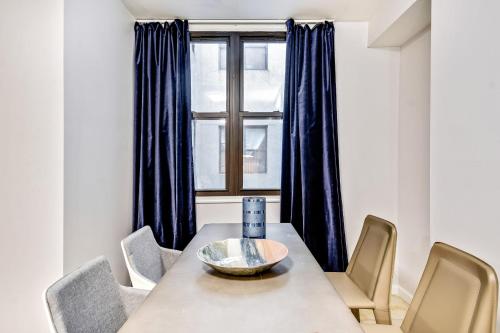 a dining room with a table and chairs and a window at Spacious 1BD Apt in the heart of City in Philadelphia