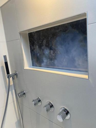 a bathroom with a window above a shower at Alp Hotel in Amsterdam
