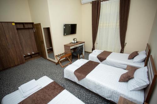 Un ou plusieurs lits dans un hébergement de l'établissement Rayyan Hotel Samarkand