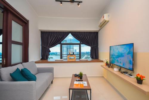 a living room with a couch and a large window at Country Garden Seaview Suite by Nest Home at Danga Bay in Johor Bahru