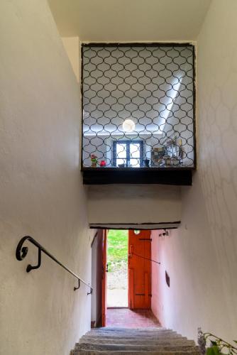 a stairway with a window and a stair case at Monastero San Silvestro in Cortona