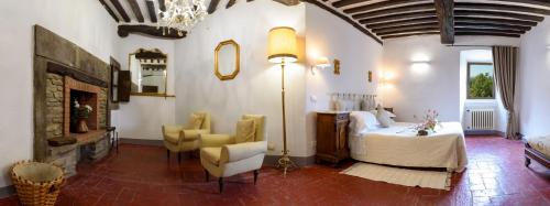 a bedroom with a bed and a table and chairs at Monastero San Silvestro in Cortona