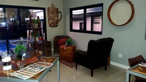 a living room with a chair and a table at The Hank Bethlehem Pty Ltd in Bethlehem