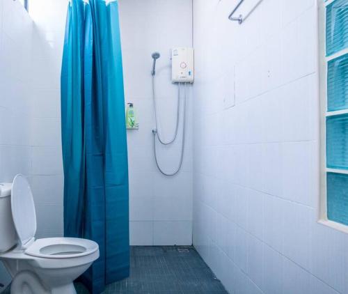 T4 Two Bedrooms Full kitchen/1 min to BTS في بانكوك: حمام مع ستارة دش زرقاء ومرحاض