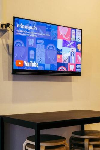 a flat screen tv hanging on a wall at T4 Two Bedrooms Full kitchen/1 min to BTS in Bangkok
