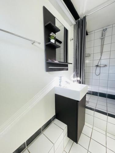 a bathroom with a sink and a shower at aday - Central Charming Apartment with Terrace in Aalborg