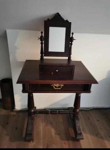 a wooden table with a mirror on top of it at Kusper Vendégház 1846 in Bükkzsérc