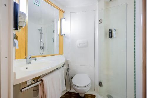 a bathroom with a sink and a toilet and a shower at ibis New Delhi Aerocity - An Accor Brand in New Delhi