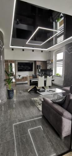 a large living room with a couch and a tv at Apartament w Tucholi in Tuchola