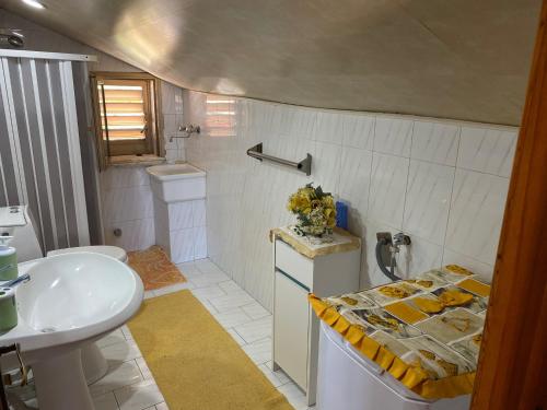 a bathroom with a sink and a toilet at Villa Grazia in Fondachello