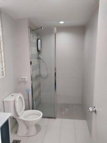 a bathroom with a toilet and a shower with a glass door at Lovely 2 bed-room Menara U Shah Alam near MSU in Shah Alam