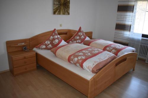 a wooden bed with pillows on it in a room at Ferienwohnung Hanke in Riedenburg