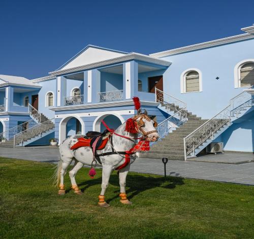 a horse standing in front of a house at Red Tullip MD Valley Resort and Spa in Udaipur