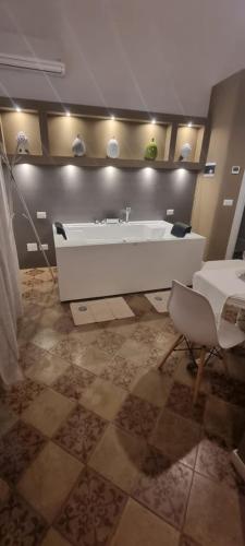 a bathroom with a white tub and a sink at ReLuxe Private Wellness in Lecce