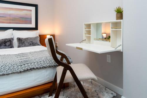 a bedroom with a bed and a chair in it at Luxury Apartments by Hyatus at Pierpont in New Haven