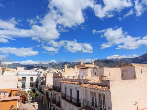a view of a city with mountains in the background at Estudio lola in Nerja