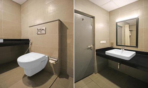 a bathroom with a toilet and a sink at Treebo Grand Legacy Shahenshah in Dehradun