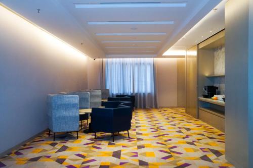 a conference room with a table and chairs on a colorful floor at Mercure Kuala Lumpur Glenmarie in Shah Alam
