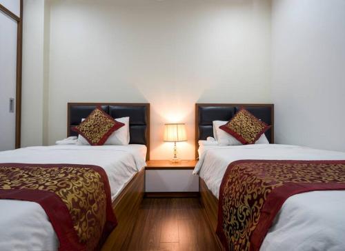 Giường trong phòng chung tại *Ha Long Homestay @ Sunrise Apartment- 4 BR