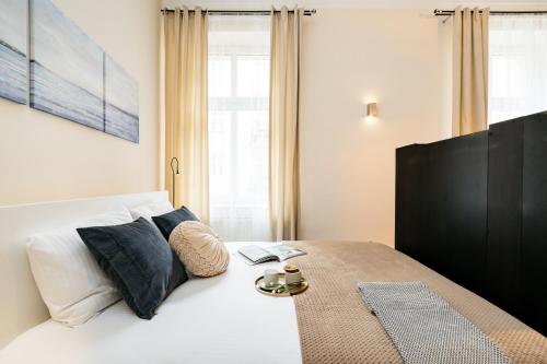 sypialnia z dużym białym łóżkiem i niebieskimi poduszkami w obiekcie Honey Apartment - LoftAffair w Krakowie