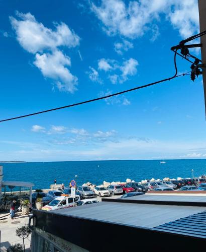 a view of the ocean from a balcony of a beach at VISUM Apartments in Piran