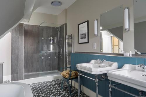 a bathroom with two sinks and a shower at Sentry Mead Hotel in Totland
