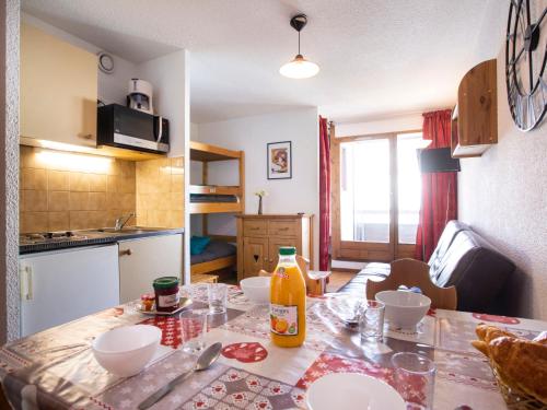 a kitchen with a table with a bottle on it at Apartment Les Cimes de Caron-14 by Interhome in Val Thorens