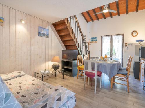 a room with a table and chairs and a bedroom at Holiday Home Le Hameau des Bougainvilliers by Interhome in Saint-Cyprien-Plage
