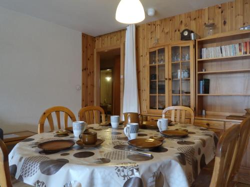 a dining room table with chairs and a table cloth at Apartment Dents Rousses C1 by Interhome in Siviez