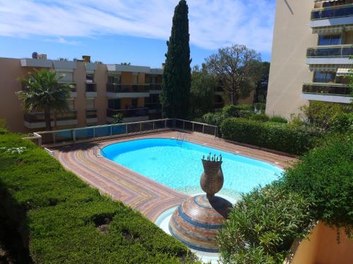 una piscina con una estatua frente a un edificio en Apartment Domaine du Clairfontaine by Interhome, en Niza