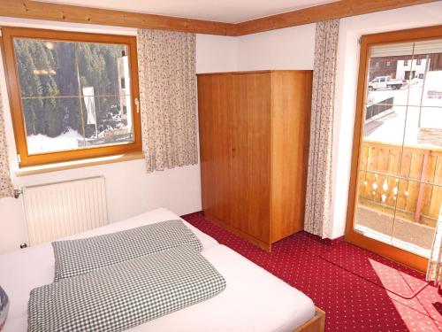 a bedroom with a bed and a window at Apartment Alpenhof-1 by Interhome in Sinsen